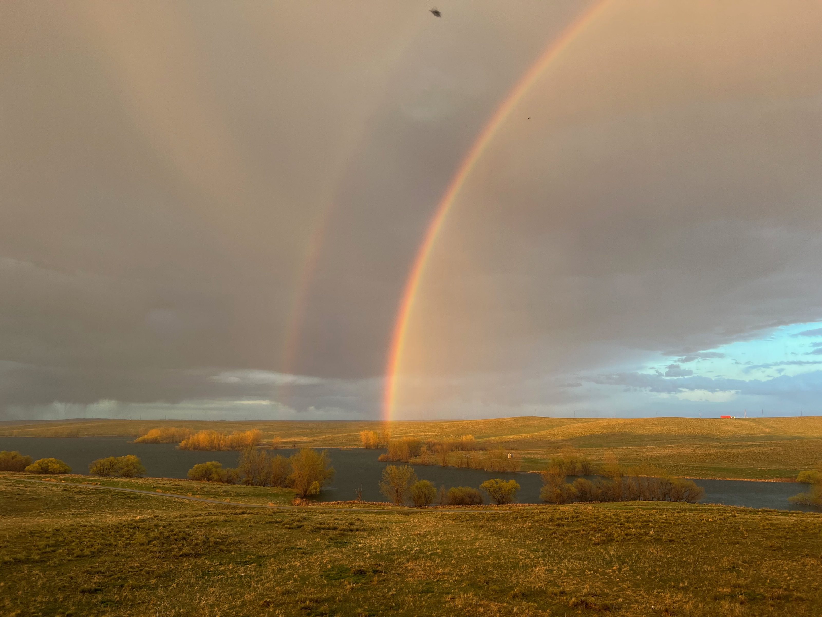 Aurora Reservoir view with a rainbow over open prairie.