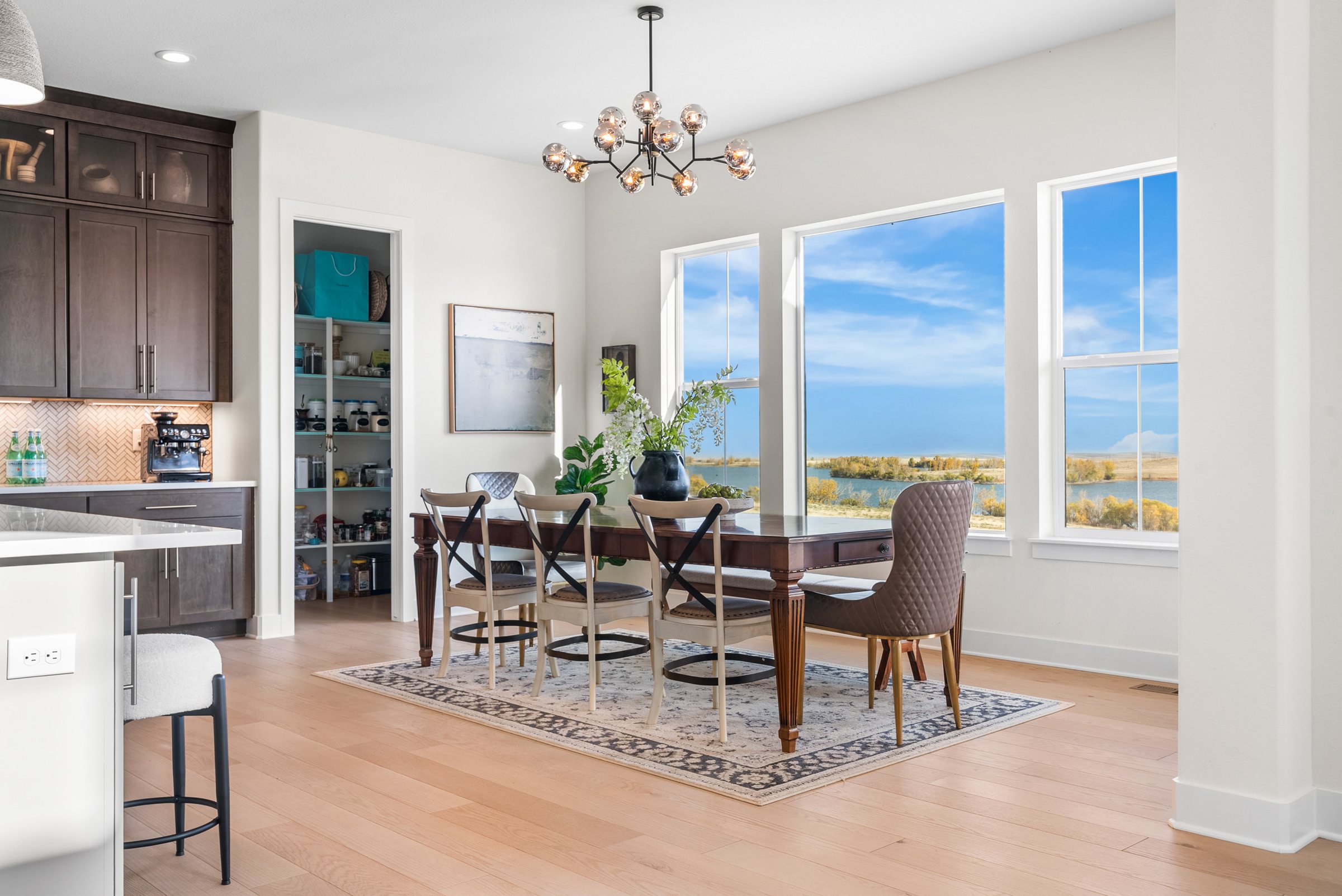 Dining nook and kitchen with large view windows.