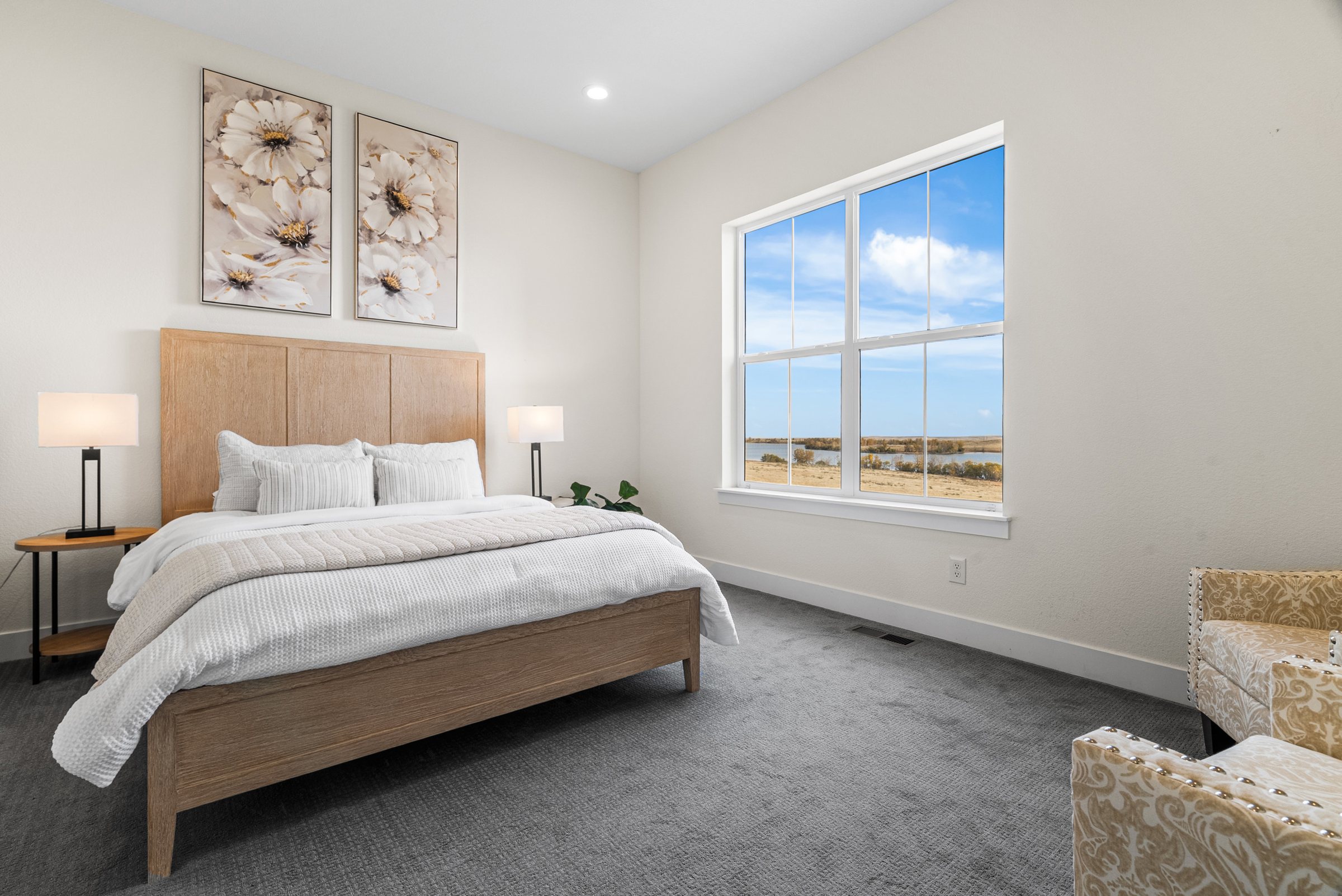 Bedroom with wide window and prairie outlook.