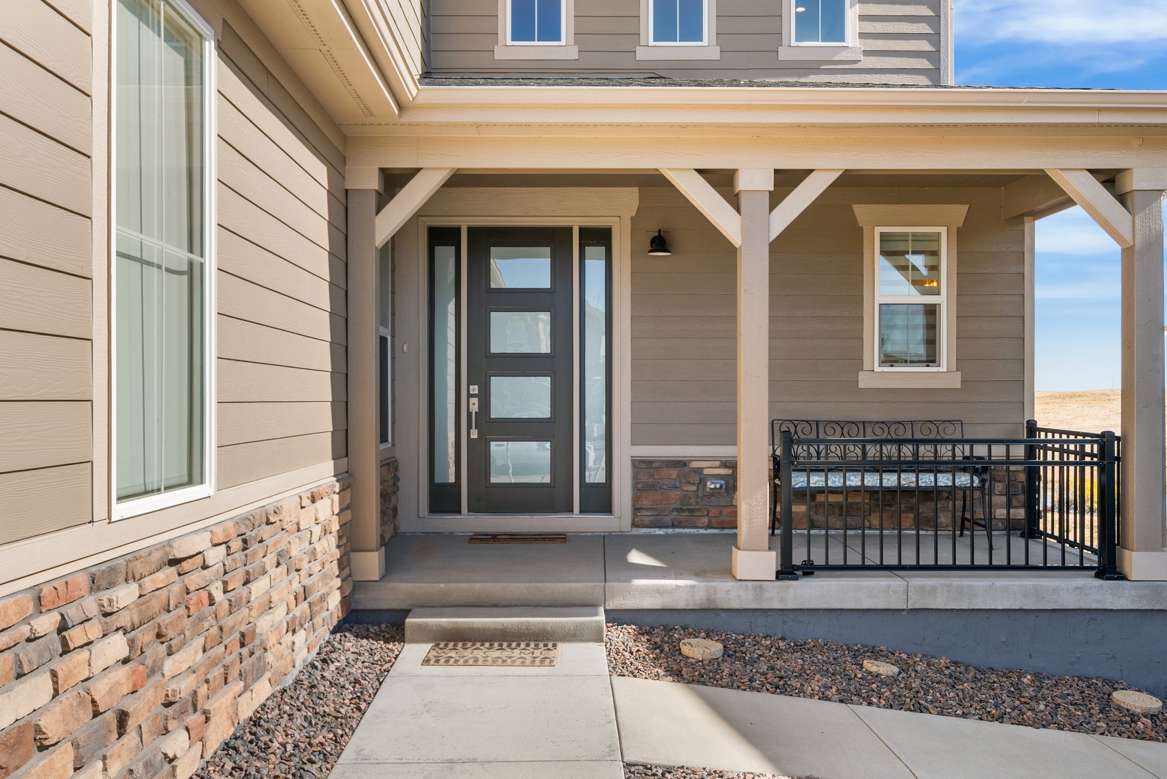 Covered front entry and modern front door.
