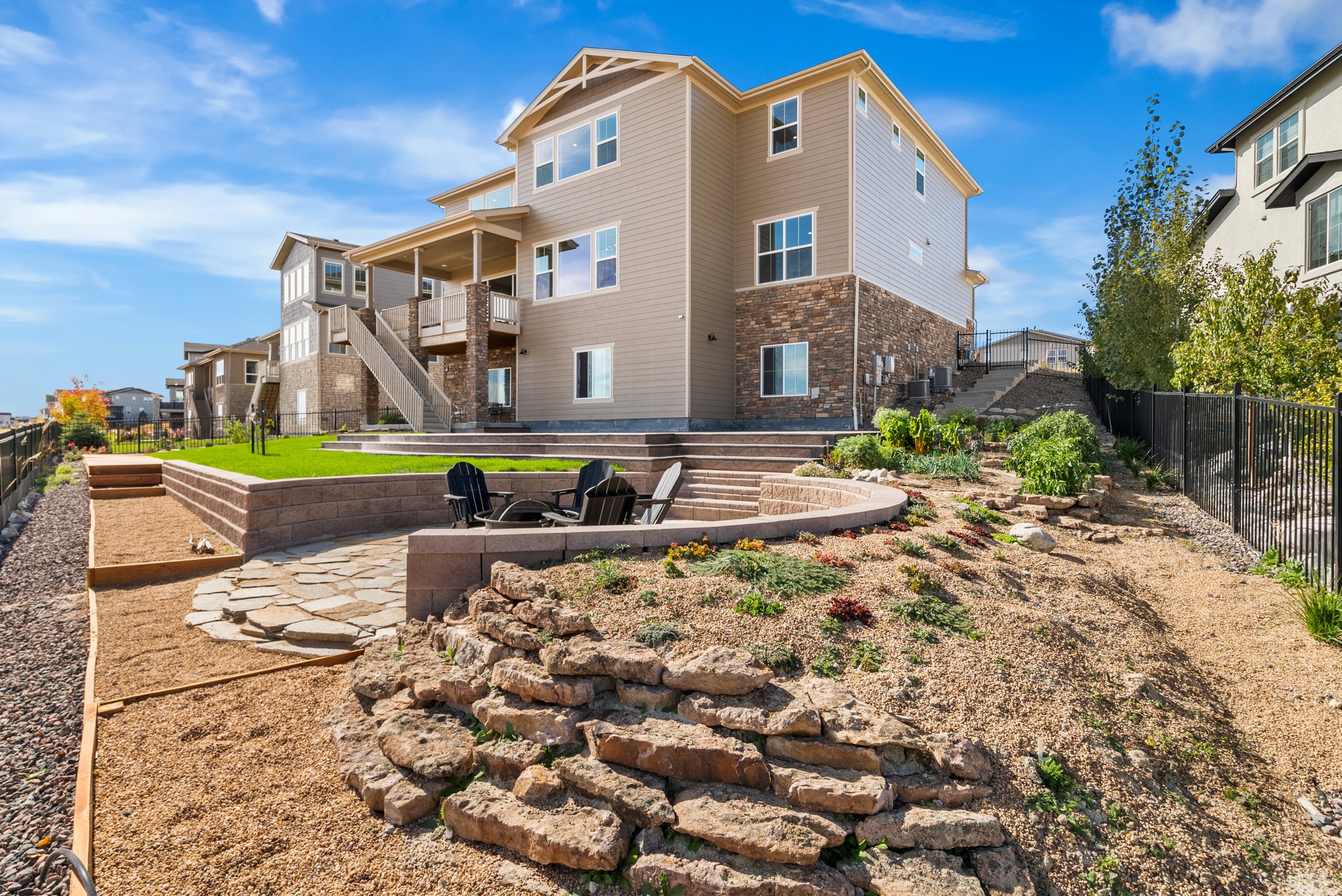 Rear elevation with landscaped yard and open-space outlook.